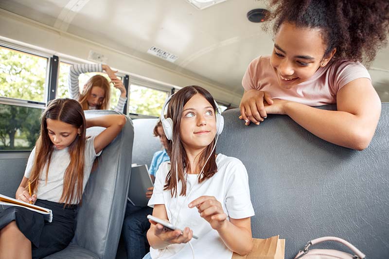 Group of children classmates going to school by bus