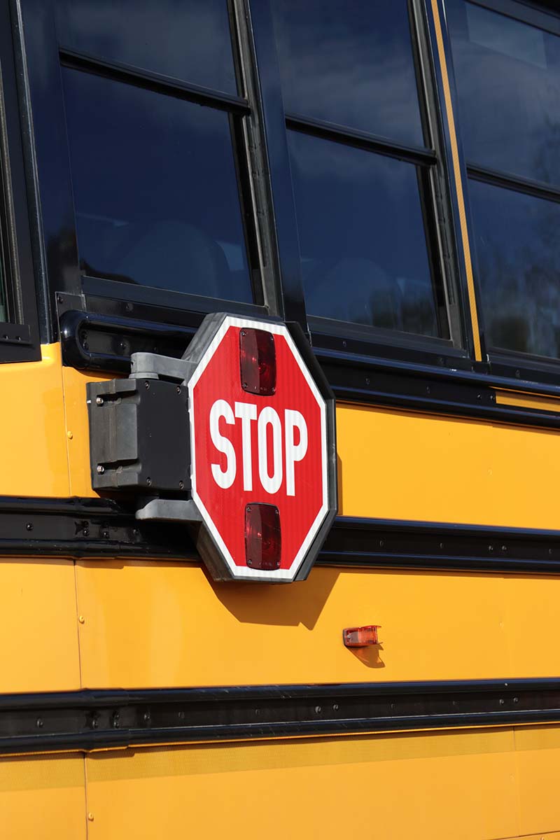 Stop sign on the side of a school bus