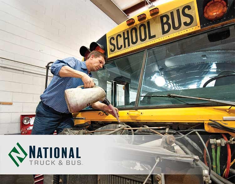 Man performaing maintiance on school bus - National Truck & Bus