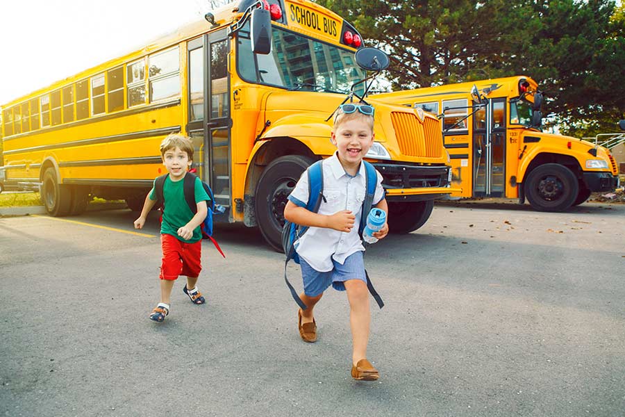 Two children getting out of used school bus
